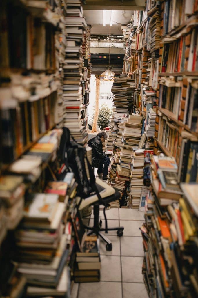 Created by: Photo by Guilherme Rossi: https://www.pexels.com/photo/man-sitting-in-floor-of-room-full-of-books-2553424/

Used by: The Writers for Hire, Inc