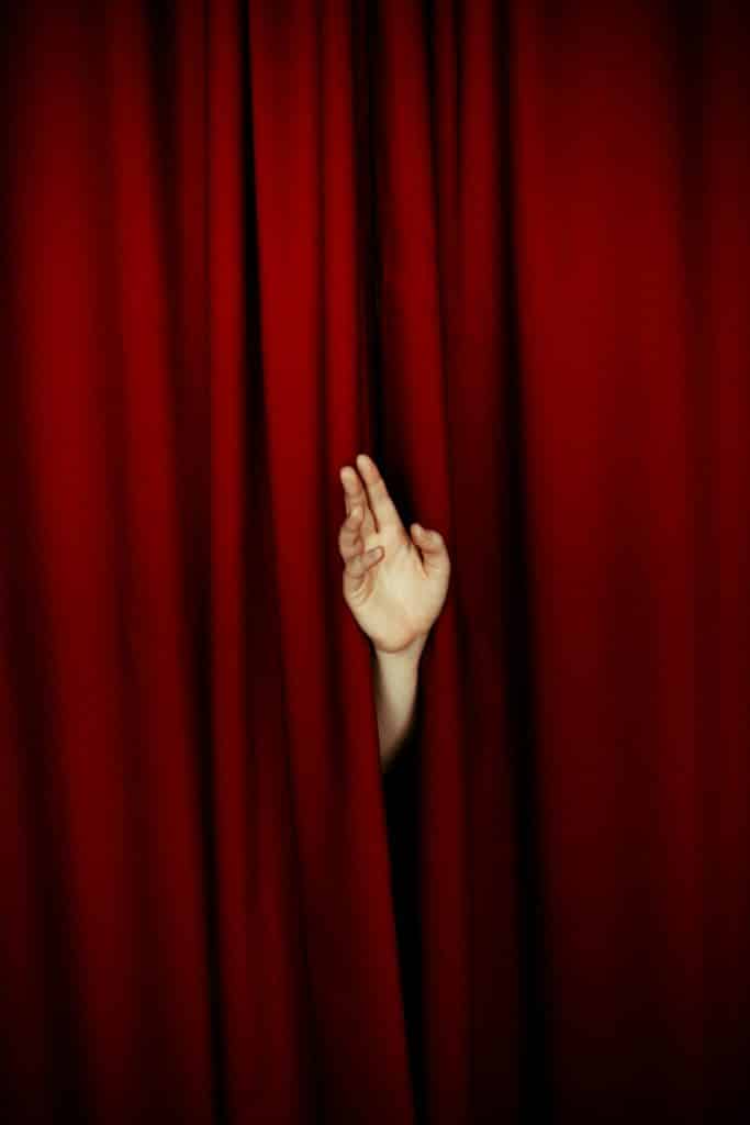 Photo by Daria Nekipelova: https://www.pexels.com/photo/human-hand-from-behind-curtain-in-theatre-9665491/

Used by: The Writers for Hire, Inc